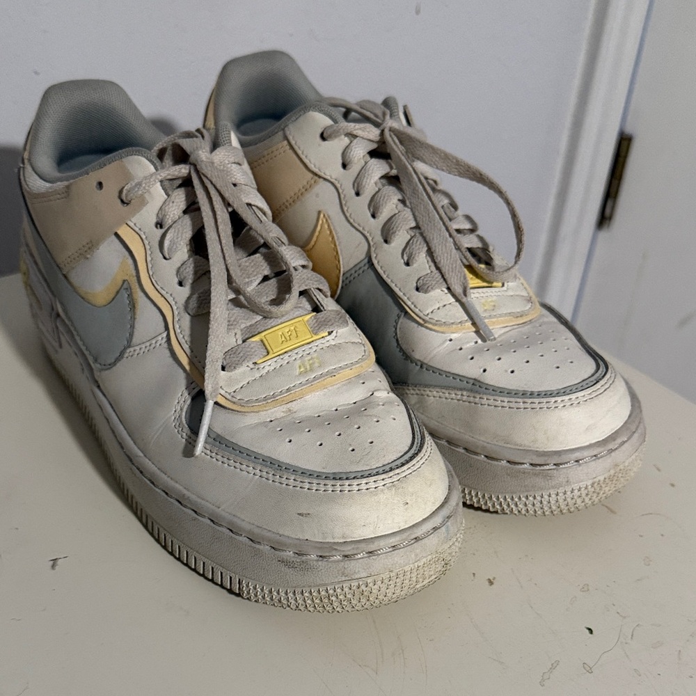 Nike Air Force 1 Low in White and Gray with Gold Accents